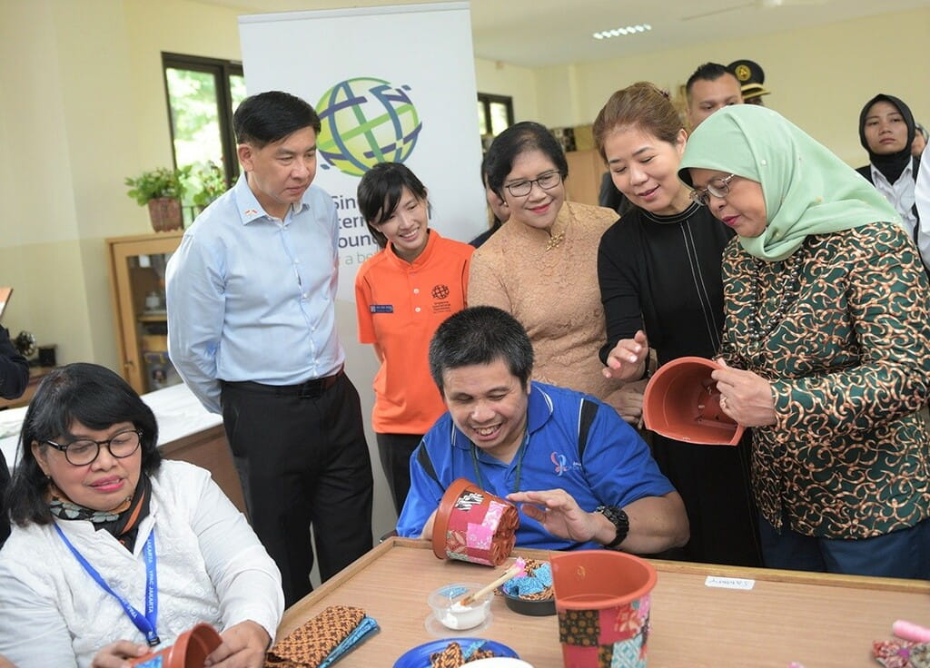 Singapore President Halimah Yacob (right) observing handicraft work by YPAC Jakarta students who are learning vocational skills to increase their job readiness